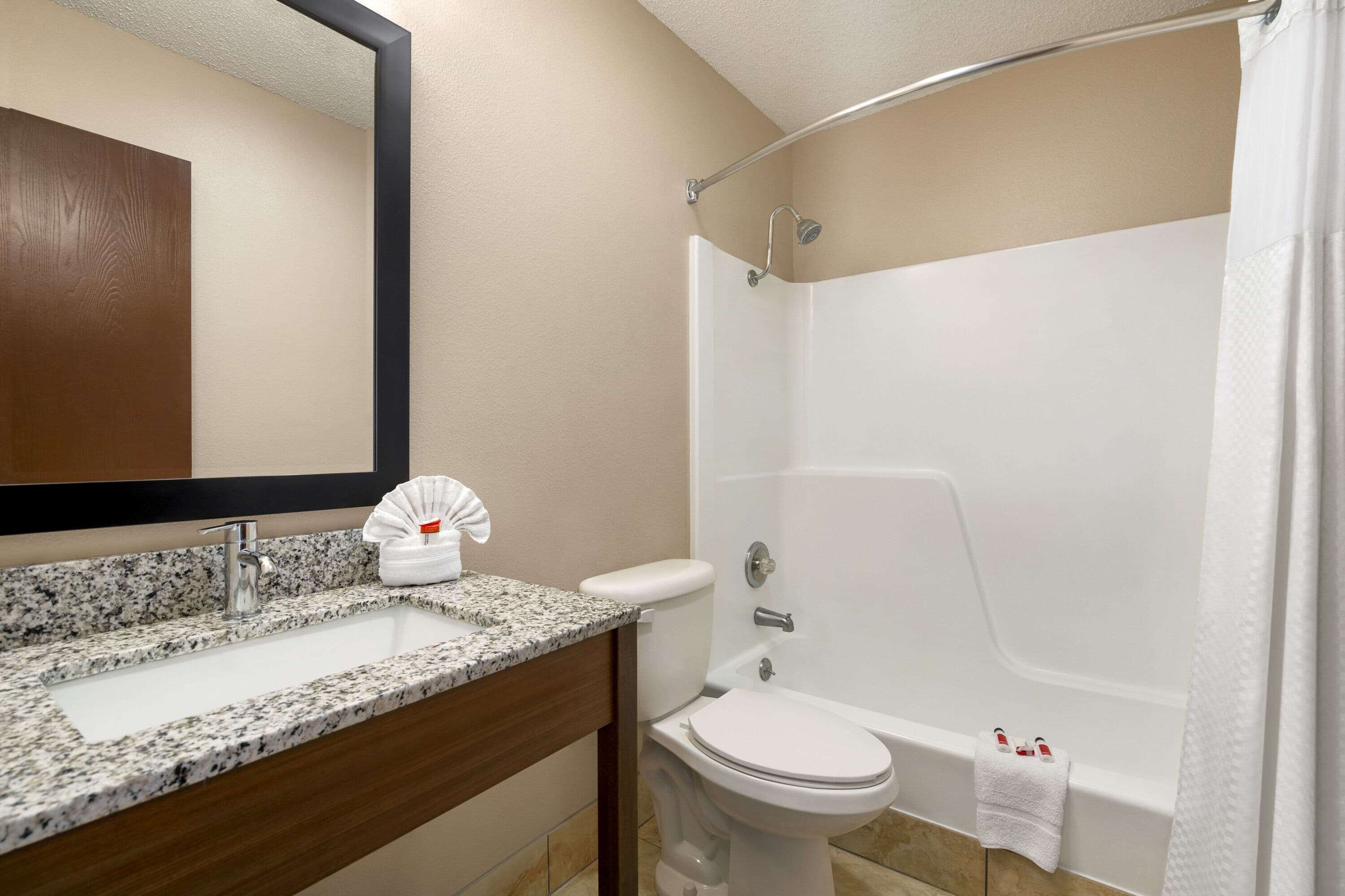 A bathroom with a sink, toilet, and shower.