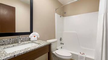 A bathroom with a sink, toilet, and shower.