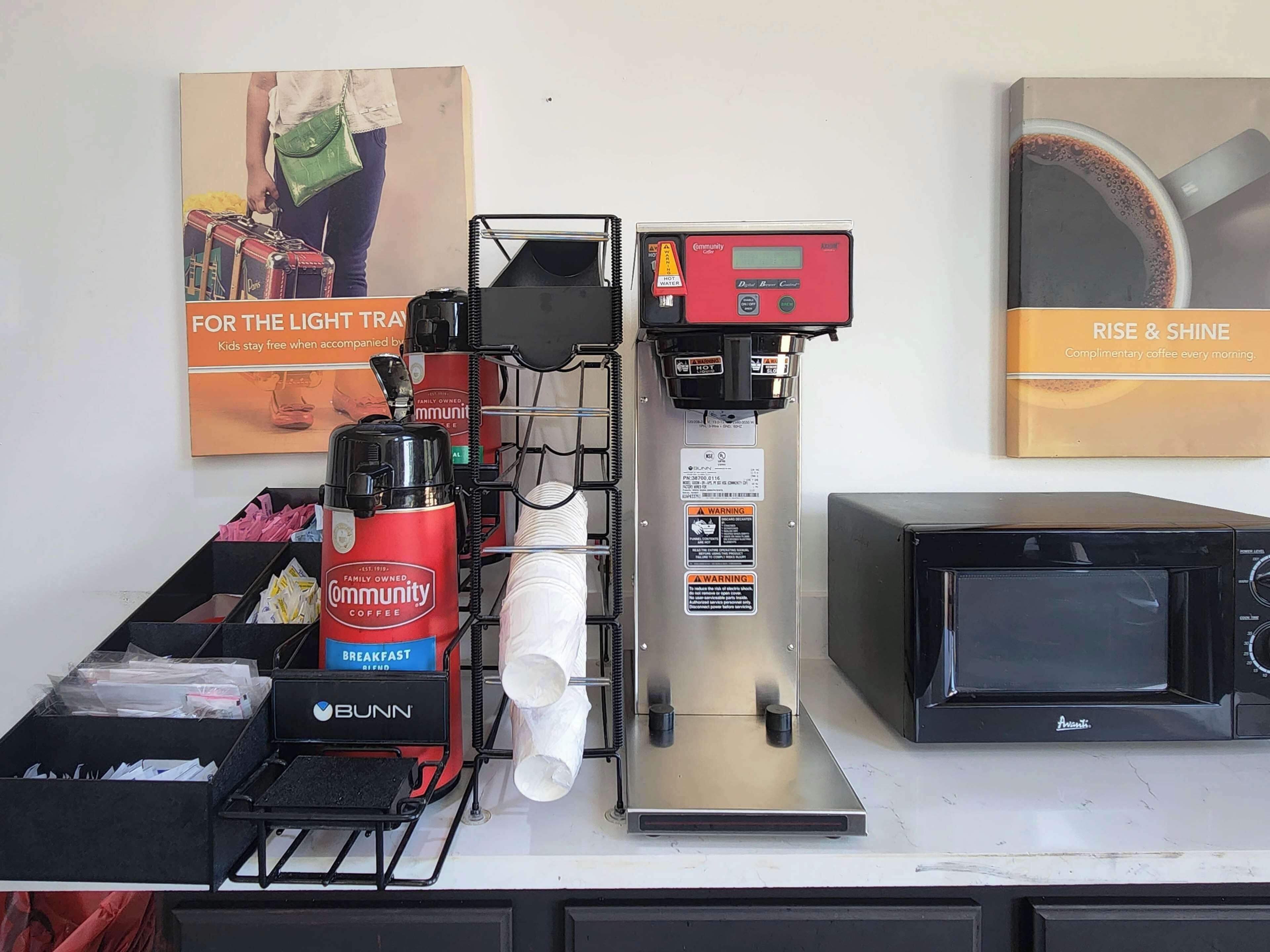 A coffee station with a coffee machine, a scale, and a microwave.