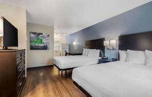A hotel room with two beds, a TV, a desk, and a refrigerator. - Extended Stay America Suites Dallas Coit Road (Dallas)