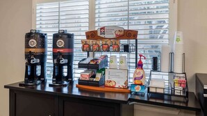 A coffee station with two coffee makers, a display of coffee pods, a coffee dispenser, and a sign advertising 'Delicious, Hearty Oatmeal'. - Extended Stay America Suites Dallas Coit Road (Dallas)