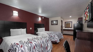 A hotel room with two beds, a desk, a television, and a bathroom. - Red Roof Inn Morgan City (Morgan City)