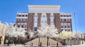 A building with a symmetrical facade, large windows, and a central entrance with steps.