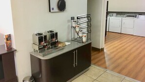 A kitchenette with a coffee machine, a sugar dispenser, and a microwave. - Americas Best Value Inn Globe AZ (Globe)