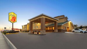 A Super 8 hotel with a covered entrance, multiple floors, and a parking lot. - Super 8 by Wyndham Dodge City (Dodge City)