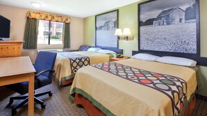A hotel room with two beds, a desk, a chair, a television, and two framed pictures on the wall.