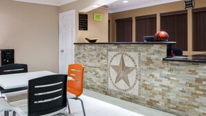A reception area with a counter, a star mosaic, and a door.