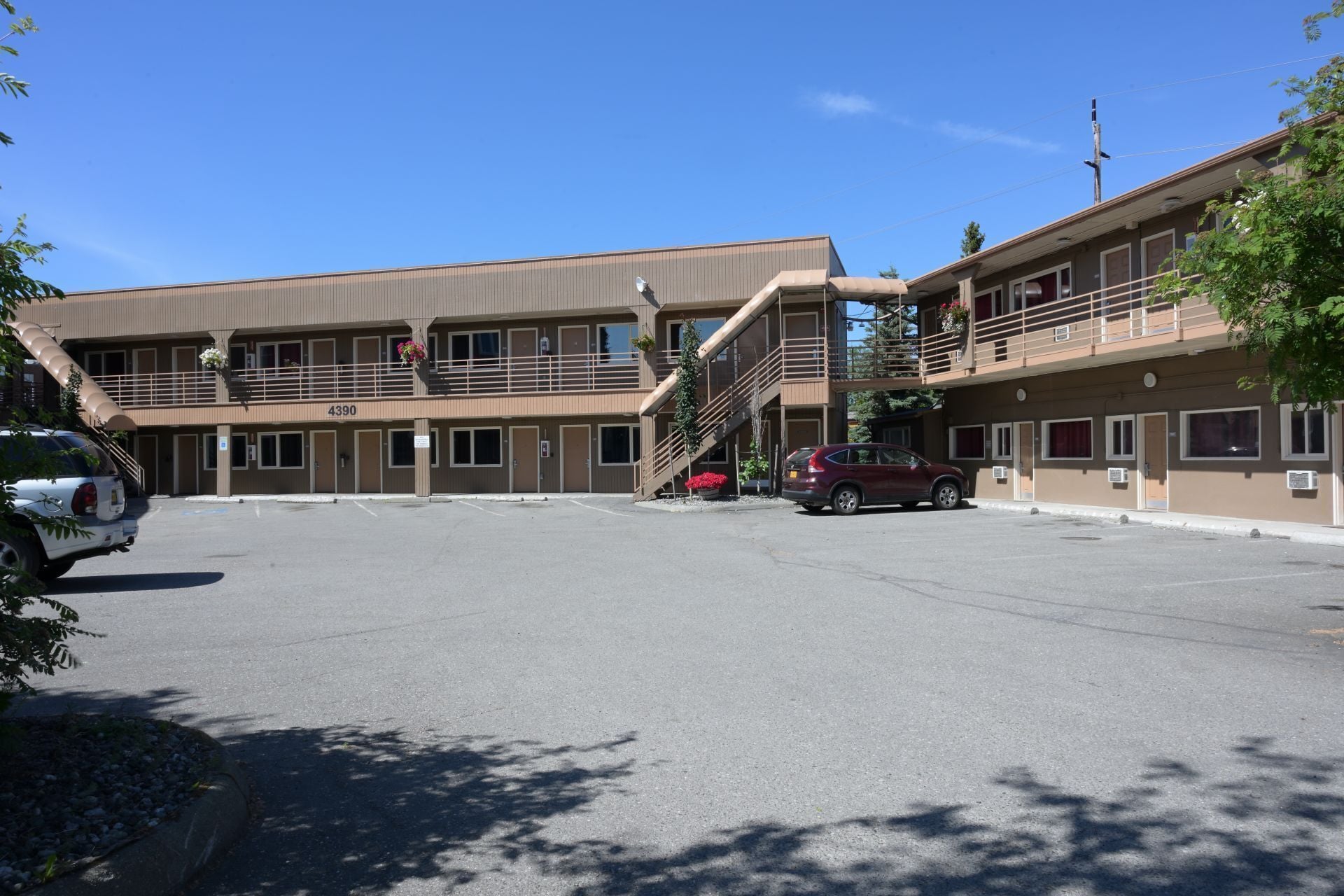 A two-story motel with a parking lot, numbered 4390.