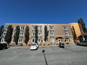 Stylish residential building with balconies and parking.