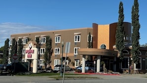 A multi-story hotel with a brown exterior, a 'DO NOT ENTER' sign, and a 'PUFFIN INN' sign.