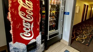 Eine Coca-Cola-Getränkeautomat und ein Wasserspender in einer Hotelhalle.
