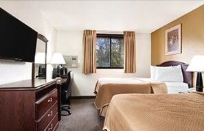 A hotel room with two beds, a desk, a dresser, a TV, and a window with curtains. - Travelodge by Wyndham La Porte/Michigan City Area (La Porte)