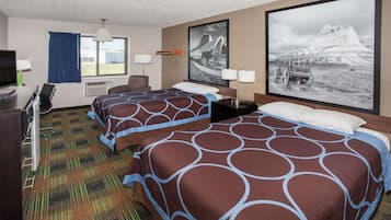 A hotel room with two beds, a desk, a TV, and a large window.