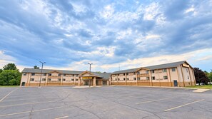 A motel with a large parking lot and a two-story building. - Super 8 by Wyndham Wisconsin Dells (Wisconsin Dells)