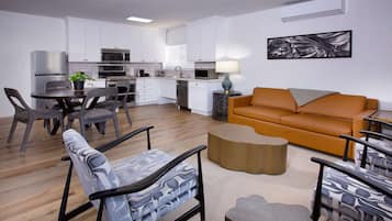 A modern apartment with a kitchen, dining area, and living room.