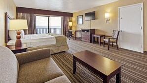 A hotel room with a bed, a desk, a chair, a TV, and a door. - Best Western Fort Myers Waterfront (North Fort Myers)