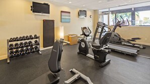 A gym with treadmills, an elliptical, a bench, and a rack of dumbbells. - Best Western Fort Myers Waterfront (North Fort Myers)