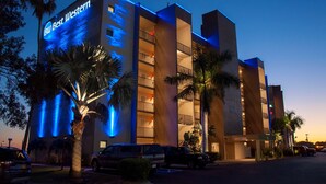 A hotel with a prominent sign reading "BW Best Western," featuring a modern design with balconies and a clear view of the surrounding area. - Best Western Fort Myers Waterfront (North Fort Myers)