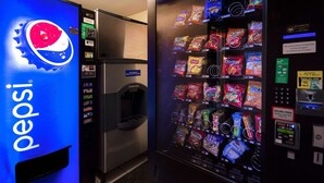 A vending machine with a Pepsi logo and a selection of snacks. - Motel 6 Merrillville, IN (Merrillville)