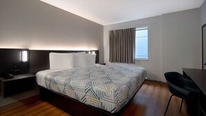 A modern hotel room with a large bed, a desk, and a chair. - Motel 6 Merrillville, IN (Merrillville)