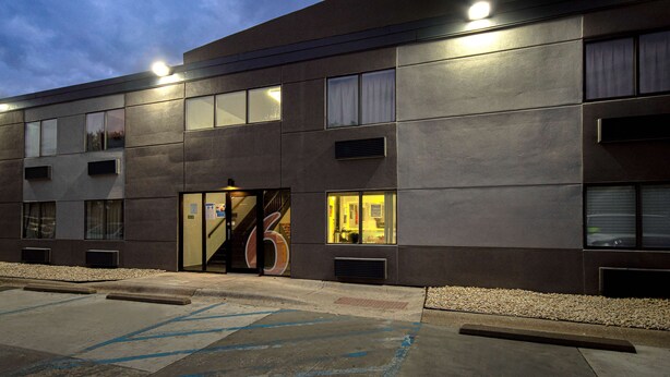 A modern building with a large glass entrance, multiple windows, and a well-lit facade. - Motel 6 Merrillville, IN (Merrillville)