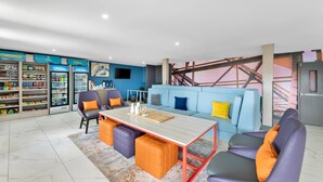 A modern living space with a sofa, chairs, a coffee table, and a snack bar.
