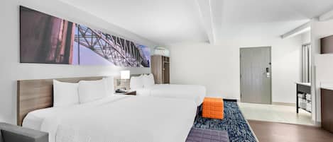 A hotel room with a large bed, two bedside tables, a desk, a chair, and a large window.