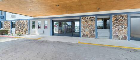 A modern building with a wooden ceiling and stone accents.