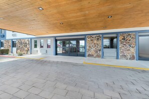 A modern building with a wooden ceiling and stone accents.
