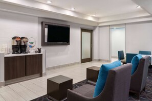 Relax in our welcoming lobby with a reception desk, coffee station, flat-screen TV, and cozy seating area.