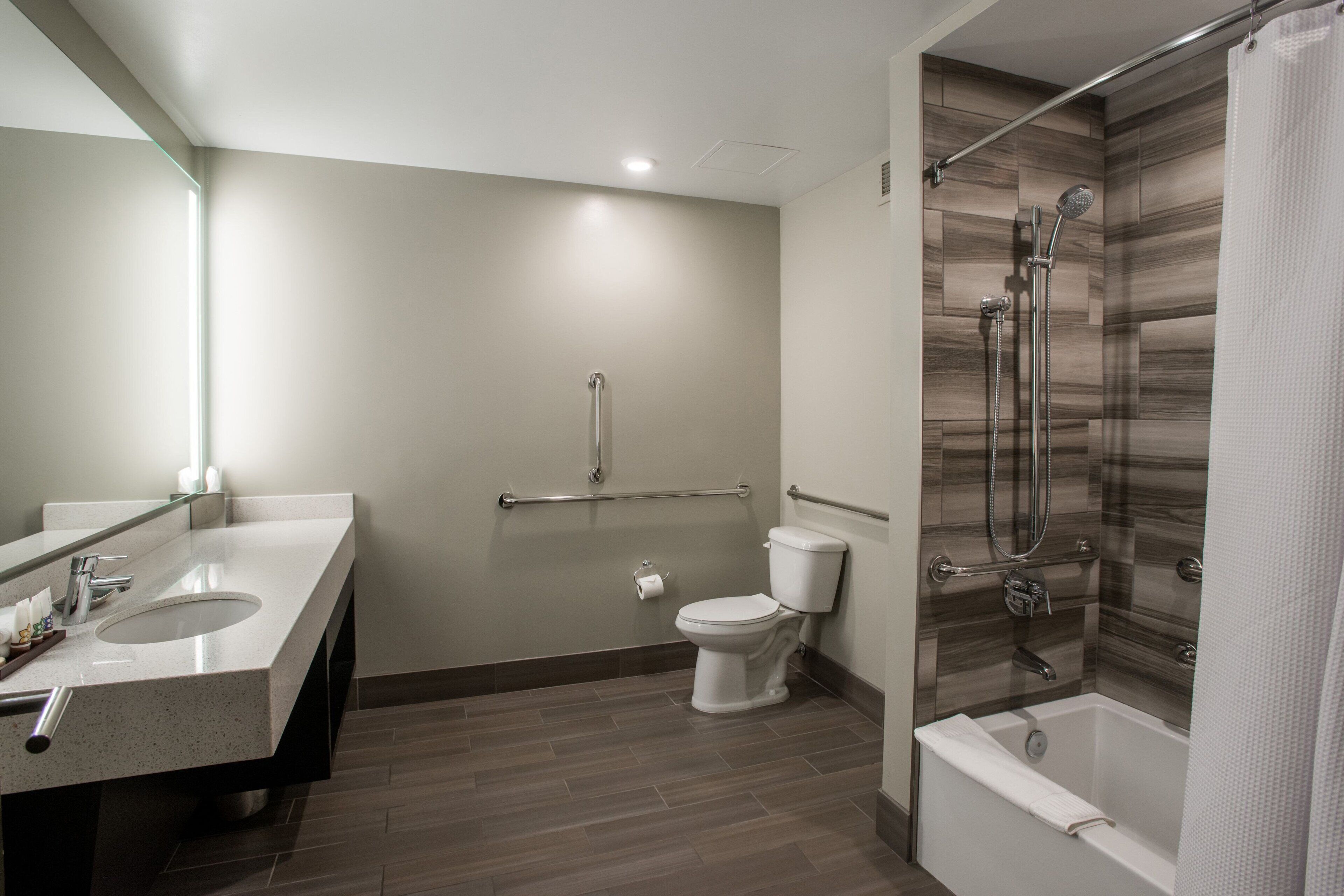 A modern bathroom with a sink, toilet, and shower.