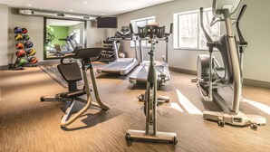 A gym with treadmills, an elliptical, and free weights. - La Quinta Inn & Suites by Wyndham Atlanta Midtown - Buckhead (Atlanta)