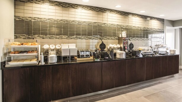 A buffet counter with various food items and kitchen appliances. - La Quinta Inn & Suites by Wyndham Atlanta Midtown - Buckhead (Atlanta)
