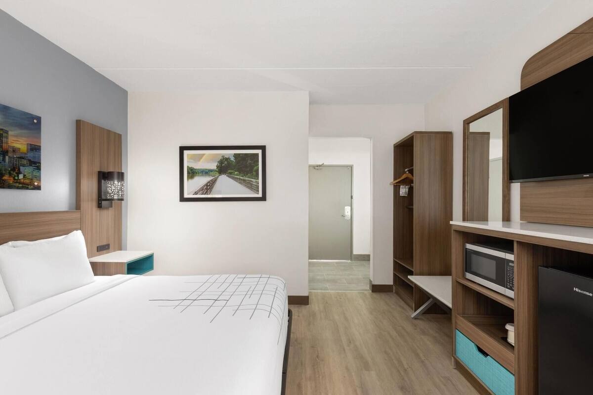 Premium bedding, desk, laptop workspace, iron/ironing board