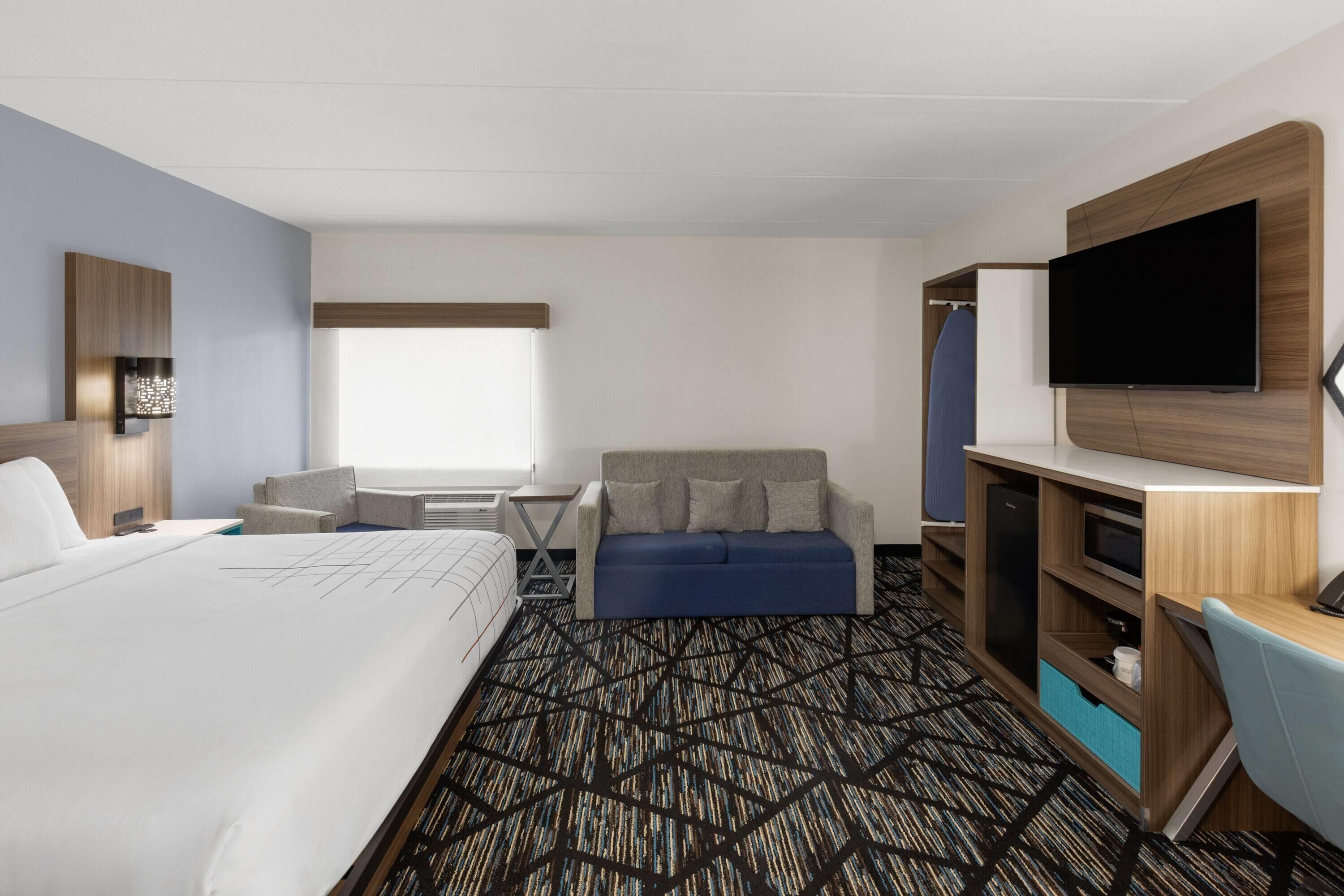 Premium bedding, desk, laptop workspace, iron/ironing board