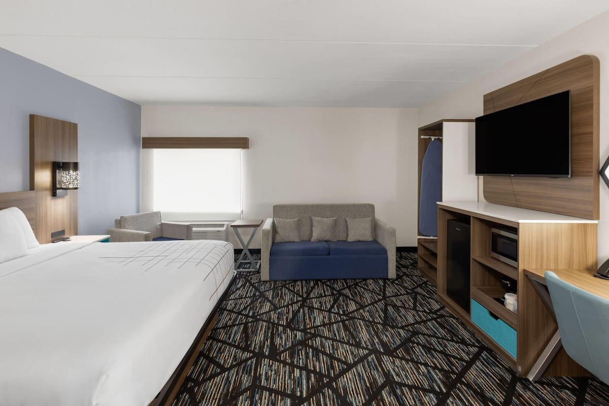 Premium bedding, desk, laptop workspace, iron/ironing board