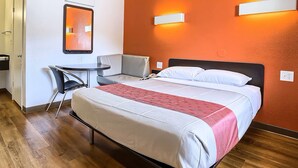 A hotel room with a bed, a desk, a chair, and a small table. - Super 8 by Wyndham Walnut Creek (Walnut Creek)