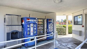 A vending machine area with a refrigerator and a Pepsi vending machine. - Super 8 by Wyndham Walnut Creek (Walnut Creek)
