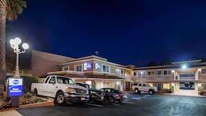 A Best Western hotel with a parking lot, multiple vehicles, and a well-lit building facade. - Best Western Poway/San Diego Hotel (Poway)