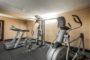 A gym with a treadmill, elliptical, and weight machine. - Quality Inn Elgin I-90 (Elgin)