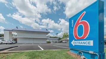 A motel with a large blue sign indicating the entrance.