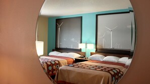 A hotel room with two beds, a large window with wind turbines, and a teal wall. - Super 8 by Wyndham Peoria East (East Peoria)