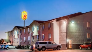 A Super 8 motel with multiple rooms, a parking lot, and a prominent sign. - Super 8 by Wyndham Abilene KS (Abilene)
