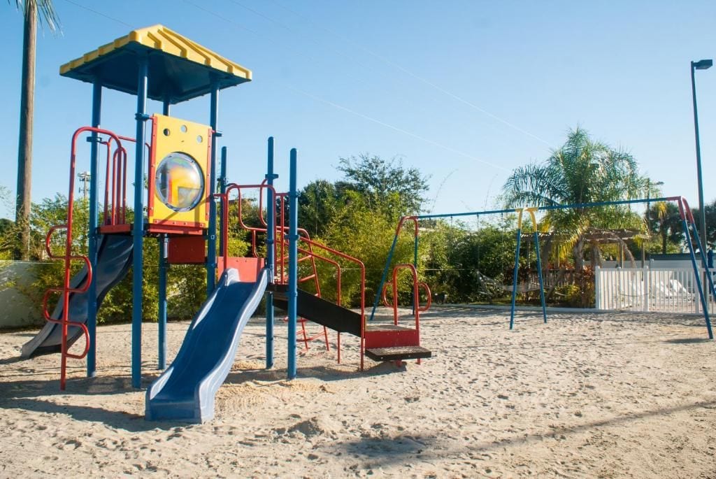 A playground with a slide and climbing structures.
