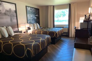 Two spacious beds, a desk, and artwork adorn this stylish room.