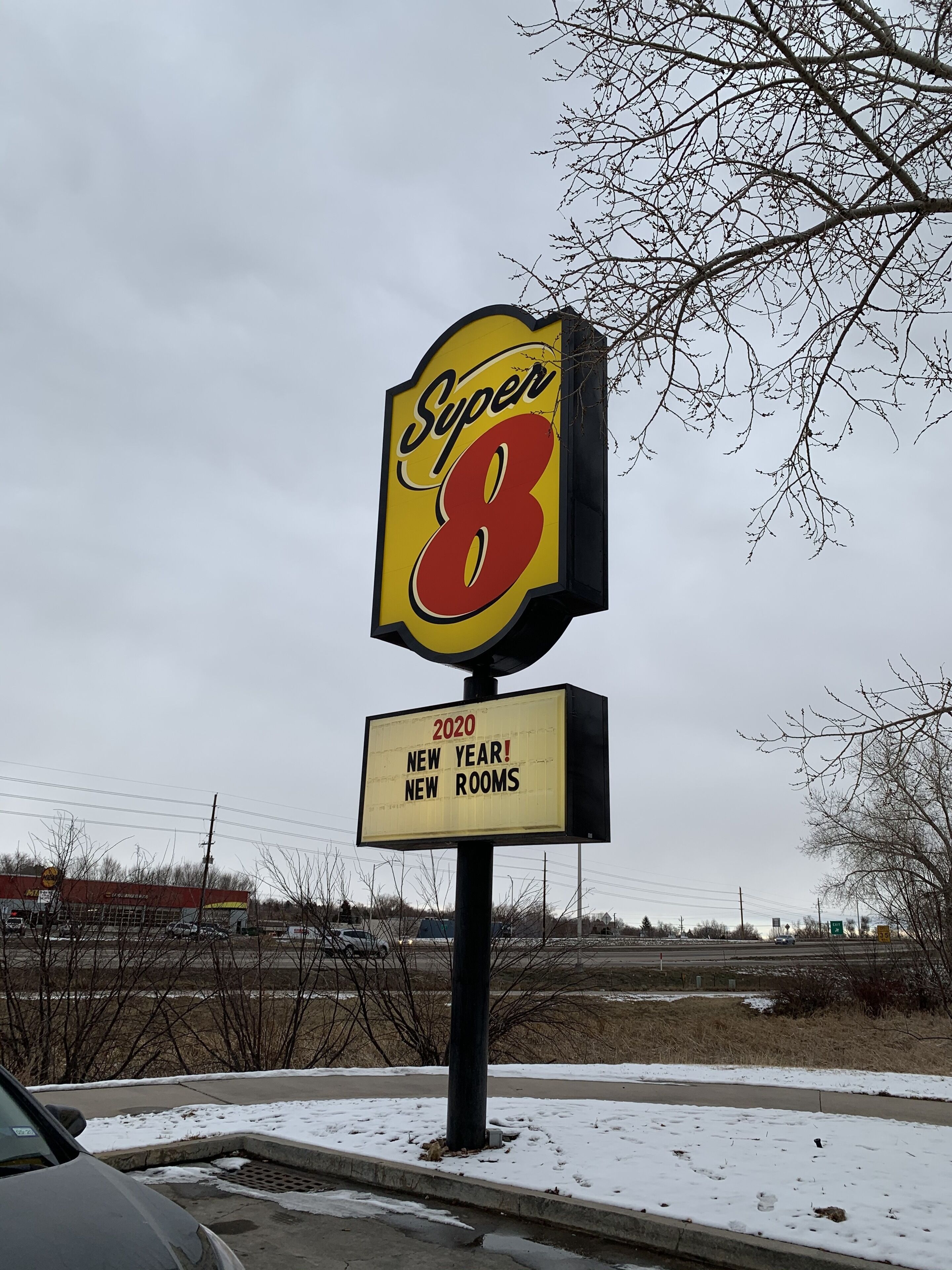 A hotel sign with "Super 8" and "2020 New Year! New Rooms" text.