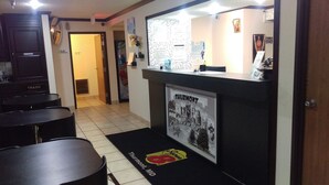 Vestíbulo de hotel con mostrador de recepción, un cubo de basura y un cartel de Thurmont, MD.
