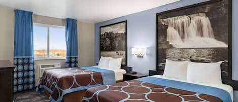 A hotel room with two beds, a large window with curtains, a wall-mounted lamp, and a waterfall painting.