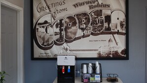 A framed welcome sign for Warner Robins, Georgia, featuring the State Capitol and the Cherokee Rose. - Super 8 by Wyndham Warner Robins (Warner Robins)