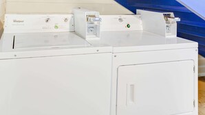 A front view of a Whirlpool washer and dryer unit with control panels and a front door. - Baymont by Wyndham Ozark (Ozark)
